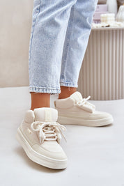 Person wearing Dovema Warm Ankle Sneakers with jeans, showcasing the stylish and insulated design for cold-weather outfits.