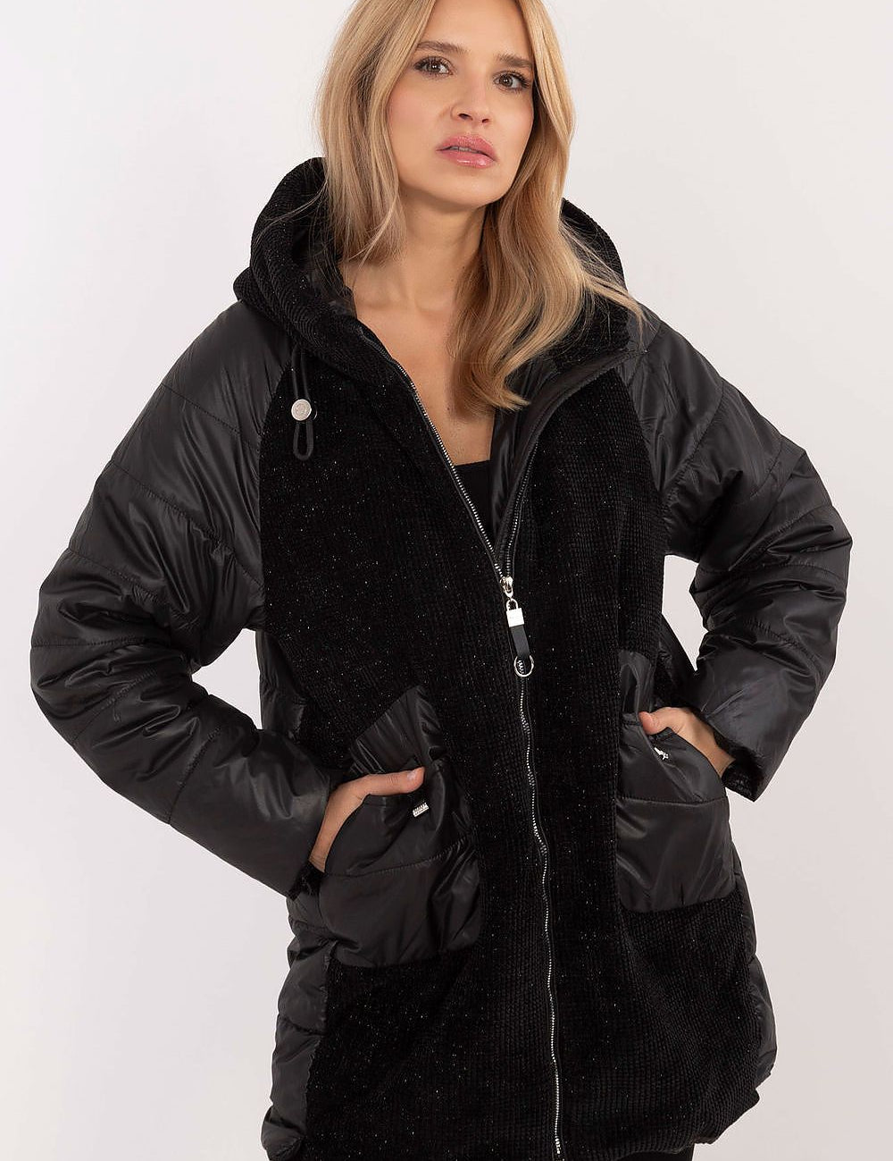 Woman wearing Cordivelle Quilted Hooded Jacket with corduroy front and quilted sections, showing zip closure and hood, in black.