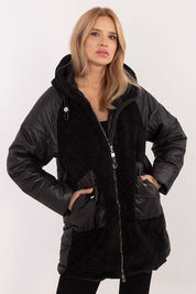 Woman wearing Cordivelle Quilted Hooded Jacket with corduroy front and quilted sections, showing zip closure and hood, in black.