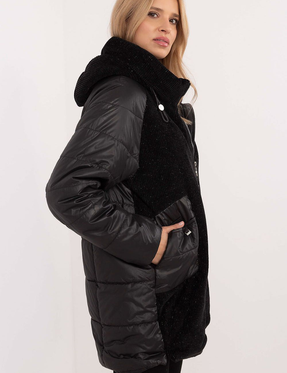 Woman wearing black Cordivelle Quilted Hooded Jacket with corduroy front and quilted panels, showcasing contemporary style and warmth.