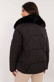 Woman wearing Merivane Quilted Fur-Collar Jacket, black with fur trim, showcasing its quilted design and elegant fur collar.
