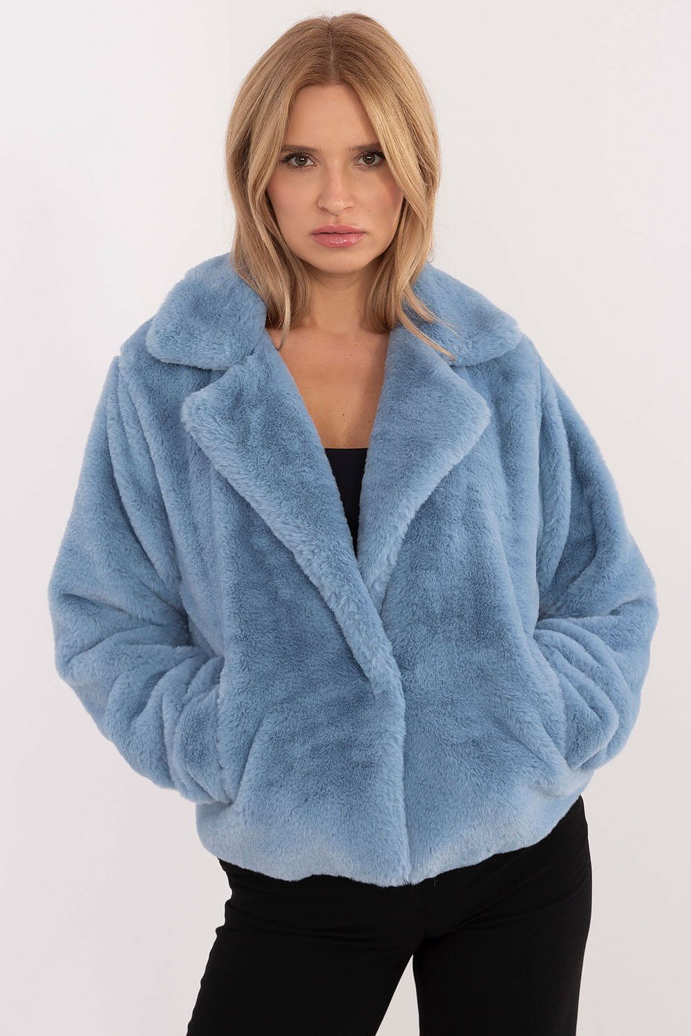 Woman wearing blue fur-collar viscose jacket with snap-front closure and slip pockets.