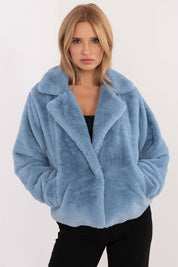 Woman wearing blue fur-collar viscose jacket with snap-front closure and slip pockets.