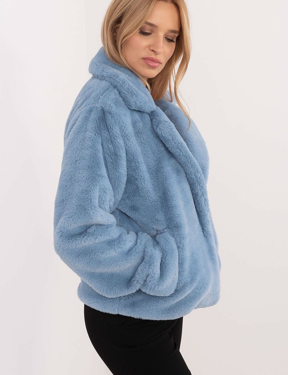 Woman wearing blue Evrosine Fur-Collar Viscose Jacket, showcasing soft fur collar and elegant design with long sleeves and discreet pockets.