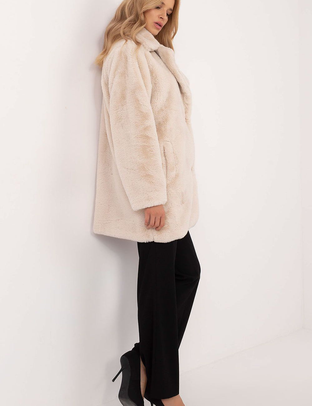 Woman wearing Cirella Viscose Mid-Season Coat, showcasing its elegant drape and beige color, perfect for autumn-winter transition.