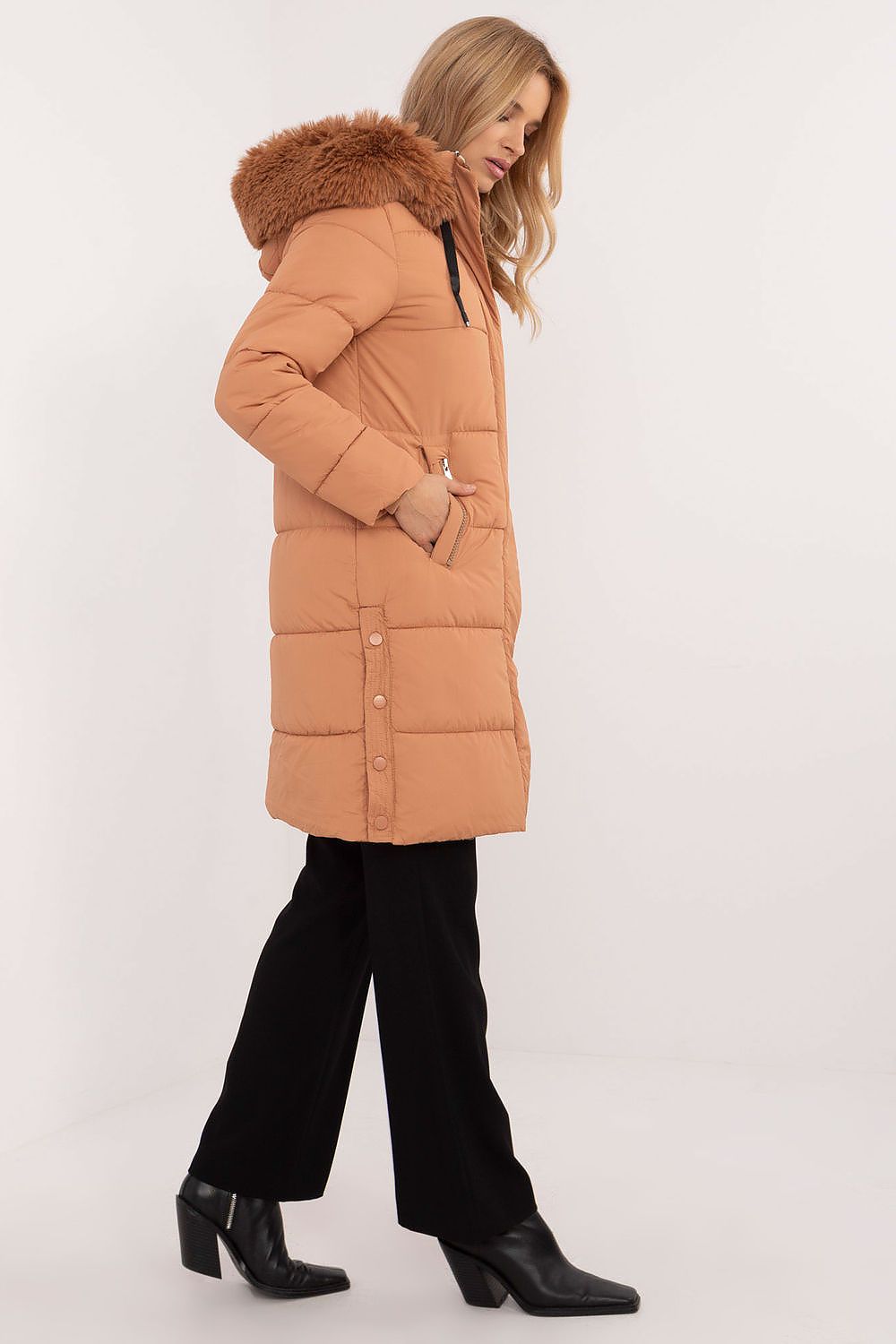 Side view of a woman wearing an Arden Quilted Longline Winter Jacket with detachable hood and fur trim, showcasing warmth and elegance.