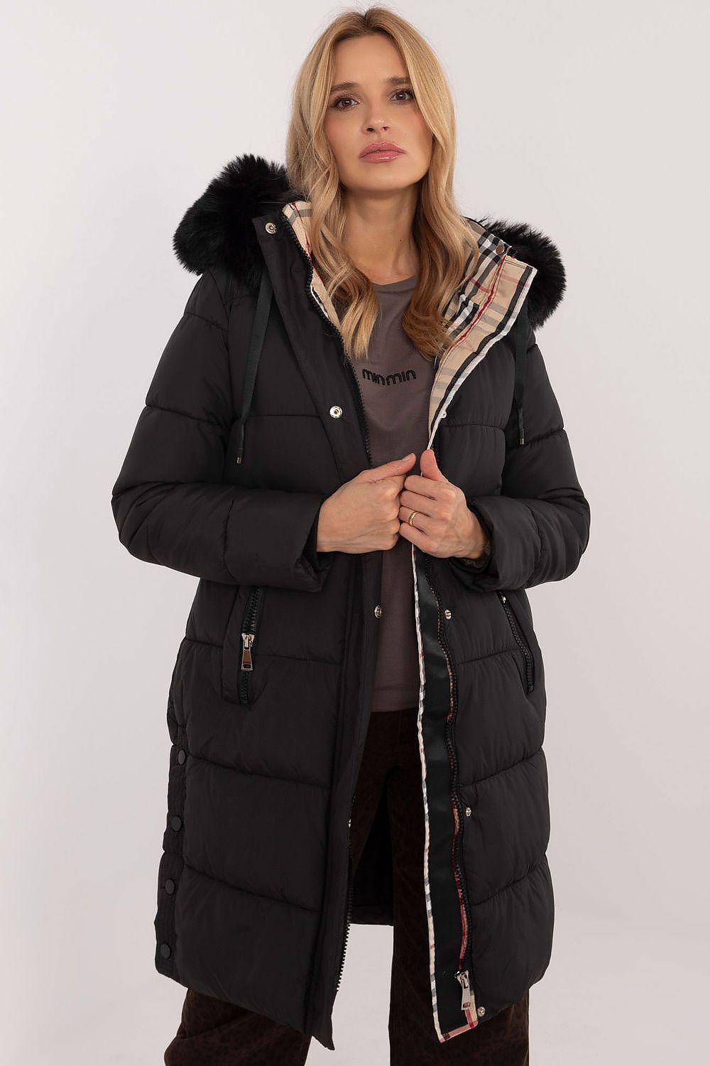 Woman wearing Arden Quilted Longline Winter Jacket with detachable hood and fur trim, showcasing warmth and style for cold seasons.