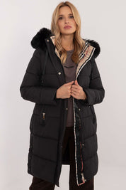 Woman wearing Arden Quilted Longline Winter Jacket with detachable hood and fur trim, showcasing warmth and style for cold seasons.