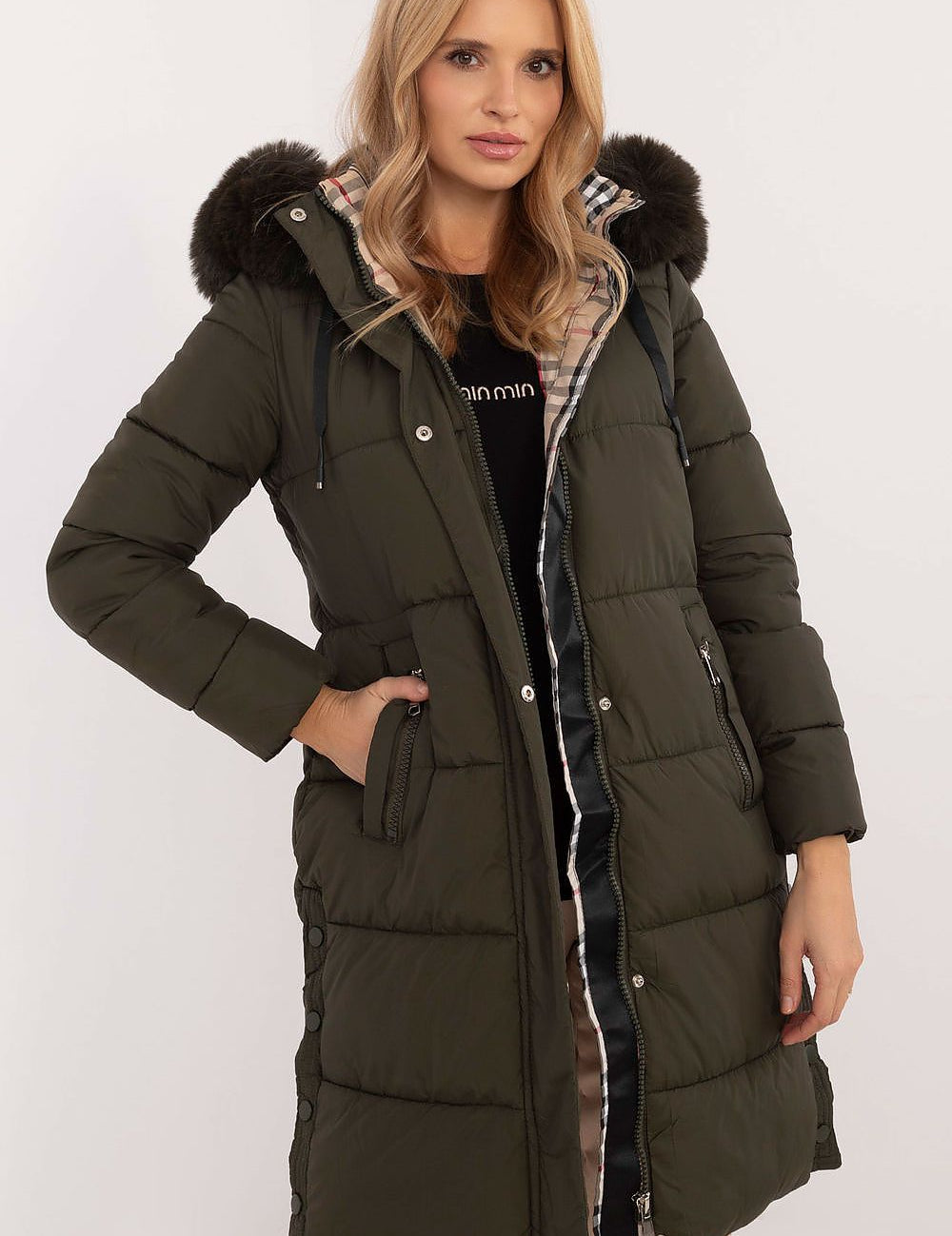 Woman wearing Arden Quilted Longline Winter Jacket with detachable hood and fur trim, offering warmth and elegance for cold seasons.
