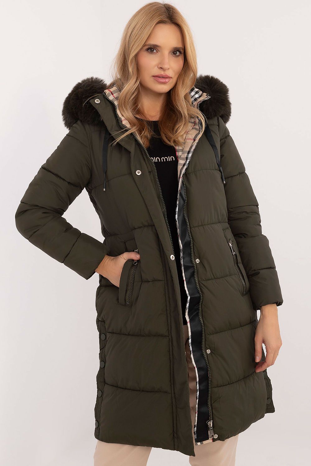 Woman wearing Arden Quilted Longline Winter Jacket with detachable hood and fur trim, offering warmth and elegance for cold seasons.
