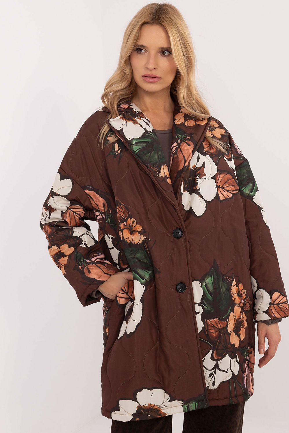 Woman wearing Florencia floral-print longline jacket with structured lapels and button closure, ideal for cooler weather.