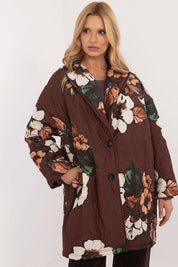 Woman wearing Florencia floral-print longline jacket with structured lapels and button closure, ideal for cooler weather.