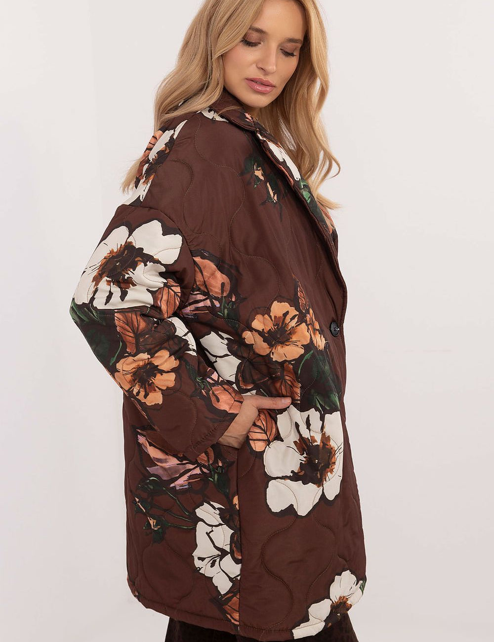 Woman wearing Florencia Floral-Print Longline Jacket with extended cut, subtle floral design, and structured lapels for elegant style.