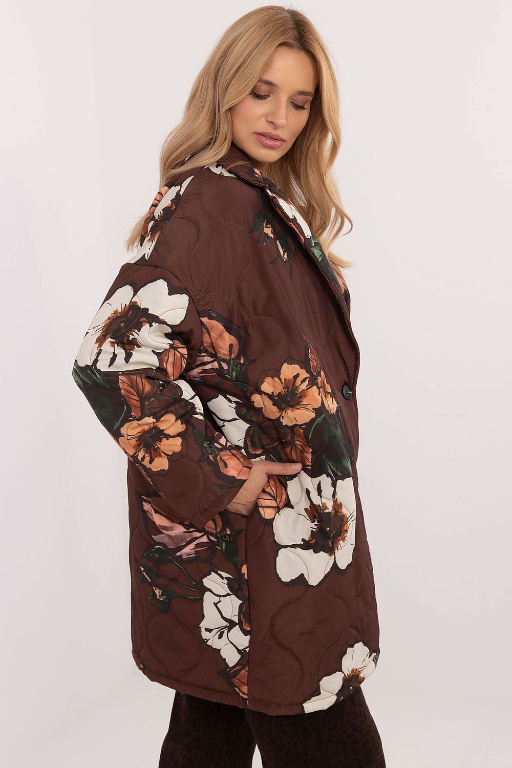 Woman wearing Florencia Floral-Print Longline Jacket with extended cut, subtle floral design, and structured lapels for elegant style.