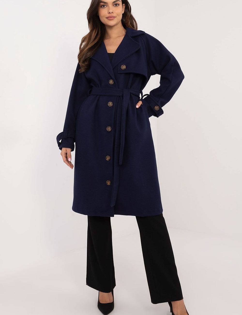 Woman wearing Meriselle belted weather-resistant trench coat with long sleeves and button closure, accentuating a sleek silhouette.
