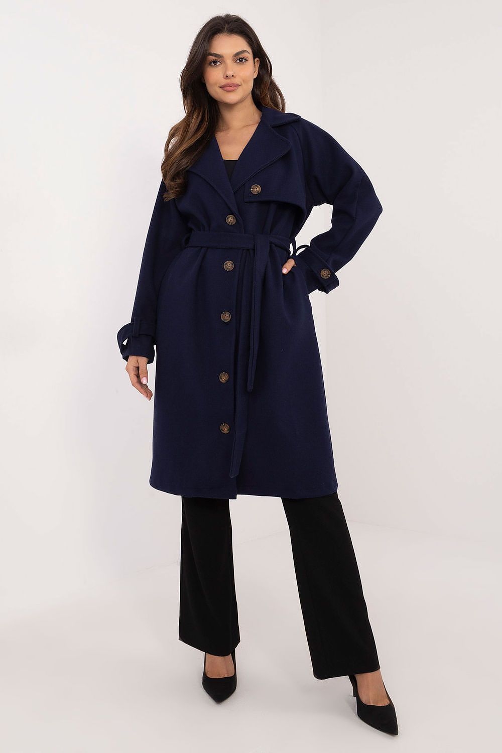 Woman wearing Meriselle belted weather-resistant trench coat with long sleeves and button closure, accentuating a sleek silhouette.