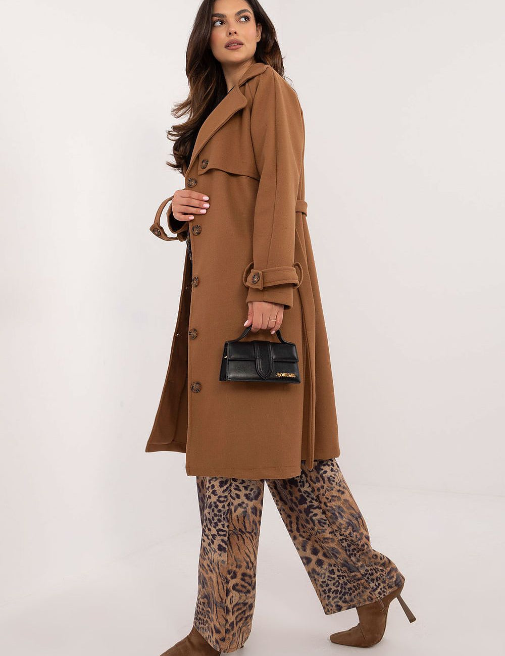 Woman wearing Meriselle Belted Weather-Resistant Trench coat, holding black handbag, styled with leopard print pants and brown heels.