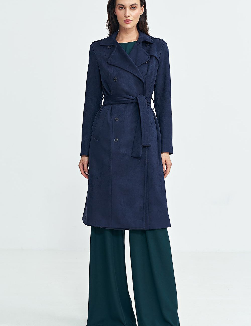 Woman wearing Aurivanne Nubuck Trench Coat, a navy blue long trench coat with a belt, showcasing classic elegance and style.