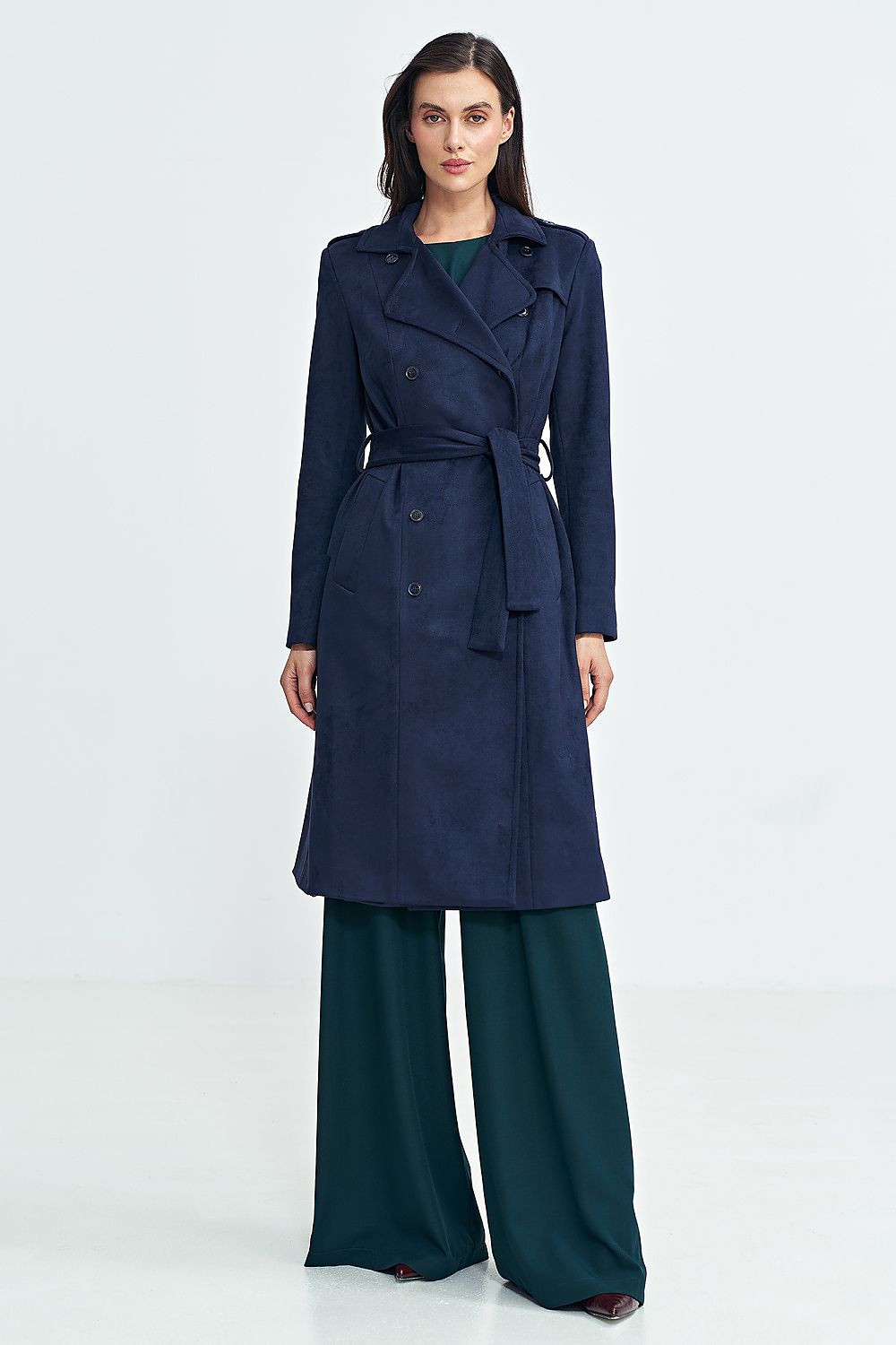 Woman wearing Aurivanne Nubuck Trench Coat, a navy blue long trench coat with a belt, showcasing classic elegance and style.