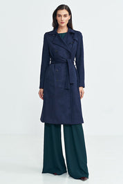 Woman wearing Aurivanne Nubuck Trench Coat, a navy blue long trench coat with a belt, showcasing classic elegance and style.