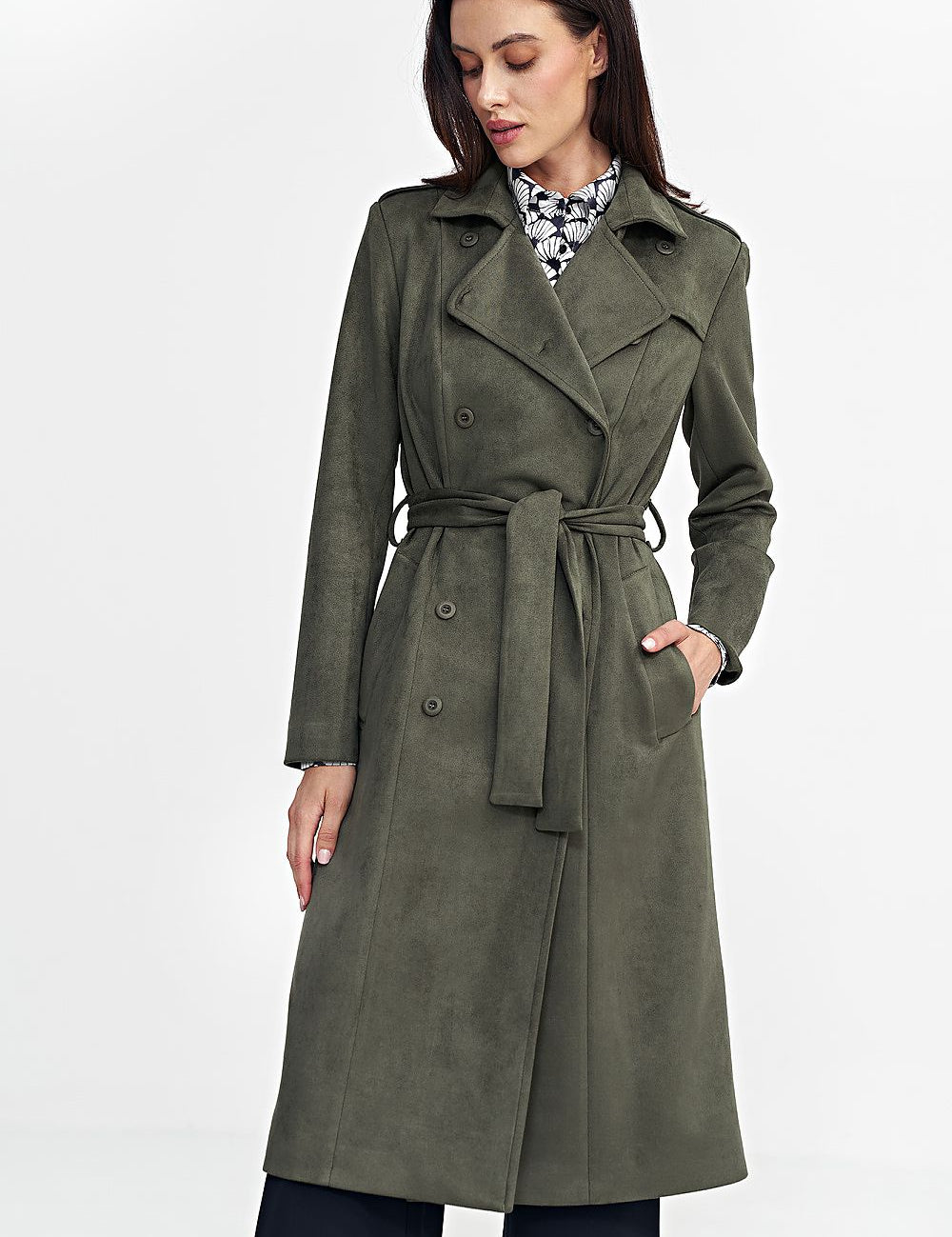 Woman wearing a green Aurivanne Nubuck Trench Coat with button closure and tie belt, displaying elegance and comfort.