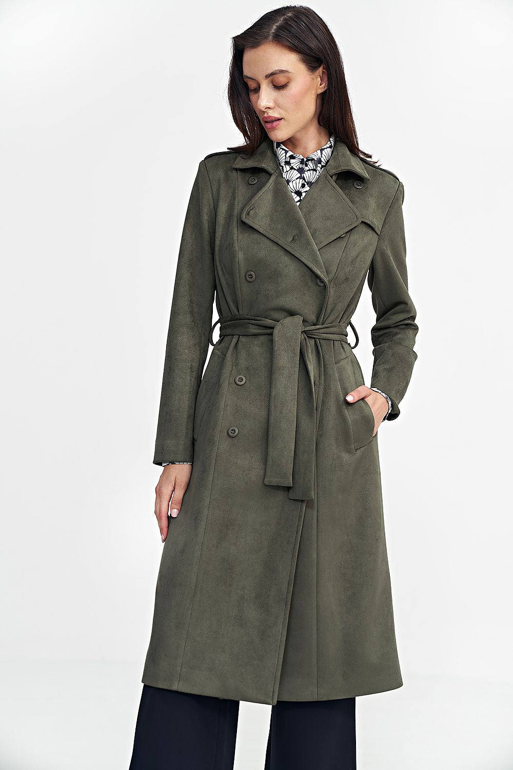 Woman wearing a green Aurivanne Nubuck Trench Coat with button closure and tie belt, displaying elegance and comfort.