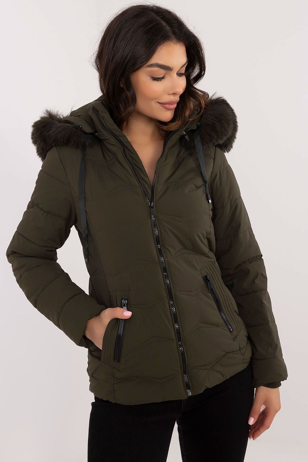 Woman wearing Veyra Short Quilted Jacket with detachable hood and front zipper, showcasing a stylish and warm design.