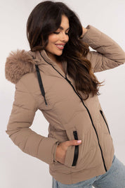 Woman wearing Veyra Short Quilted Jacket with detachable hood, demonstrating warmth and sleek style in a modern quilted design.
