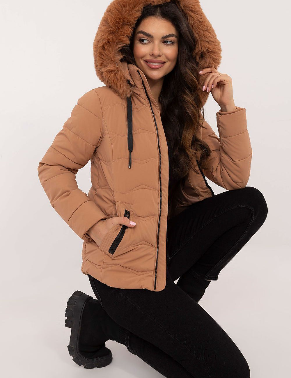 Veyra Short Quilted Jacket with faux fur hood, featuring light brown color, full front zipper, and contemporary quilted design for warmth.