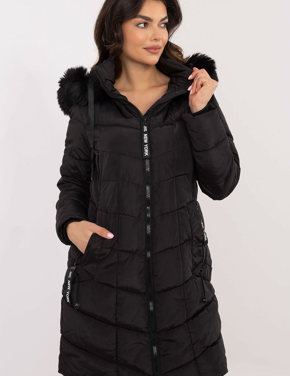 Alt Tag: Model wearing Aurlis Quilted Winter Jacket with detachable faux fur trim, showcasing warmth and style in black knee-length coat.
