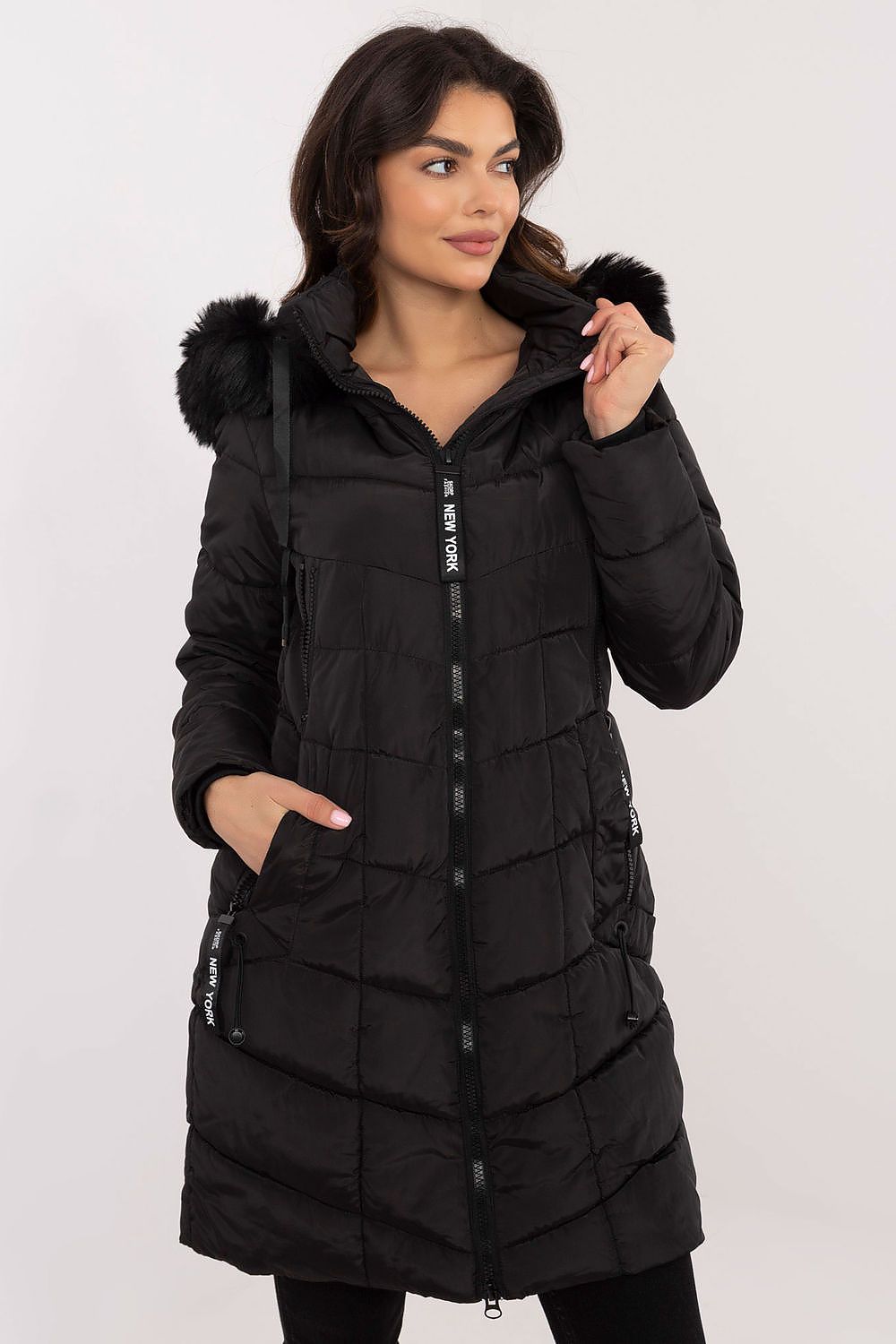 Alt Tag: Model wearing Aurlis Quilted Winter Jacket with detachable faux fur trim, showcasing warmth and style in black knee-length coat.