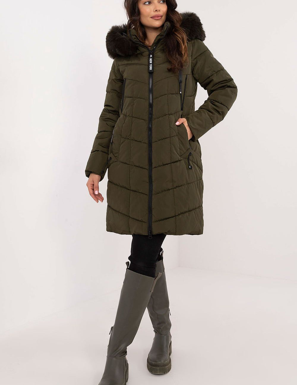 Woman wearing Aurlis Quilted Winter Jacket with faux fur trim, showcasing warmth and style for cold weather.