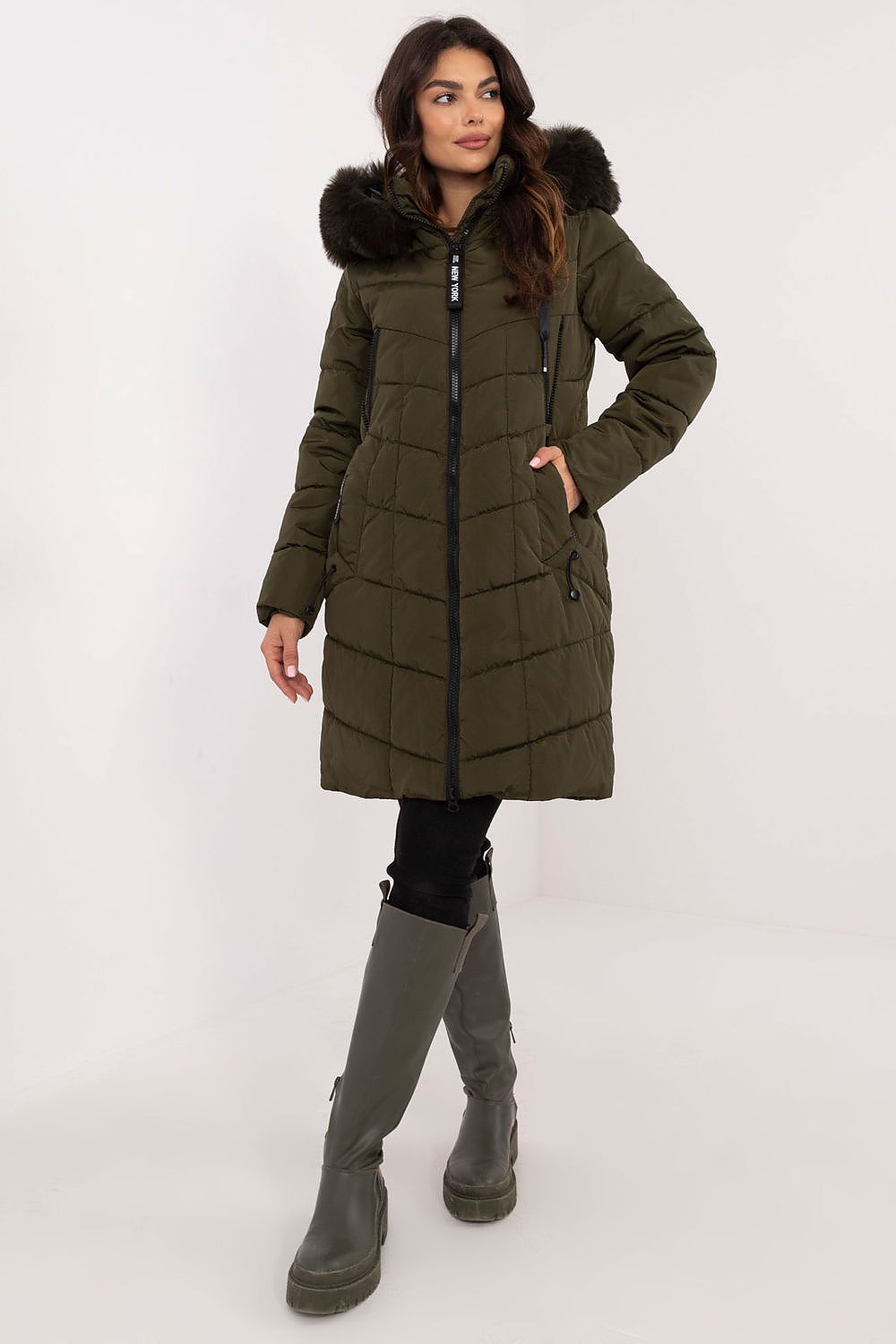 Woman wearing Aurlis Quilted Winter Jacket with faux fur trim, showcasing warmth and style for cold weather.