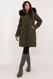 Woman wearing Aurlis Quilted Winter Jacket with faux fur trim, showcasing warmth and style for cold weather.