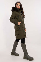 Model wearing Aurlis Quilted Winter Jacket with faux fur trim and knee-length coverage, perfect for stylish cold-weather protection.