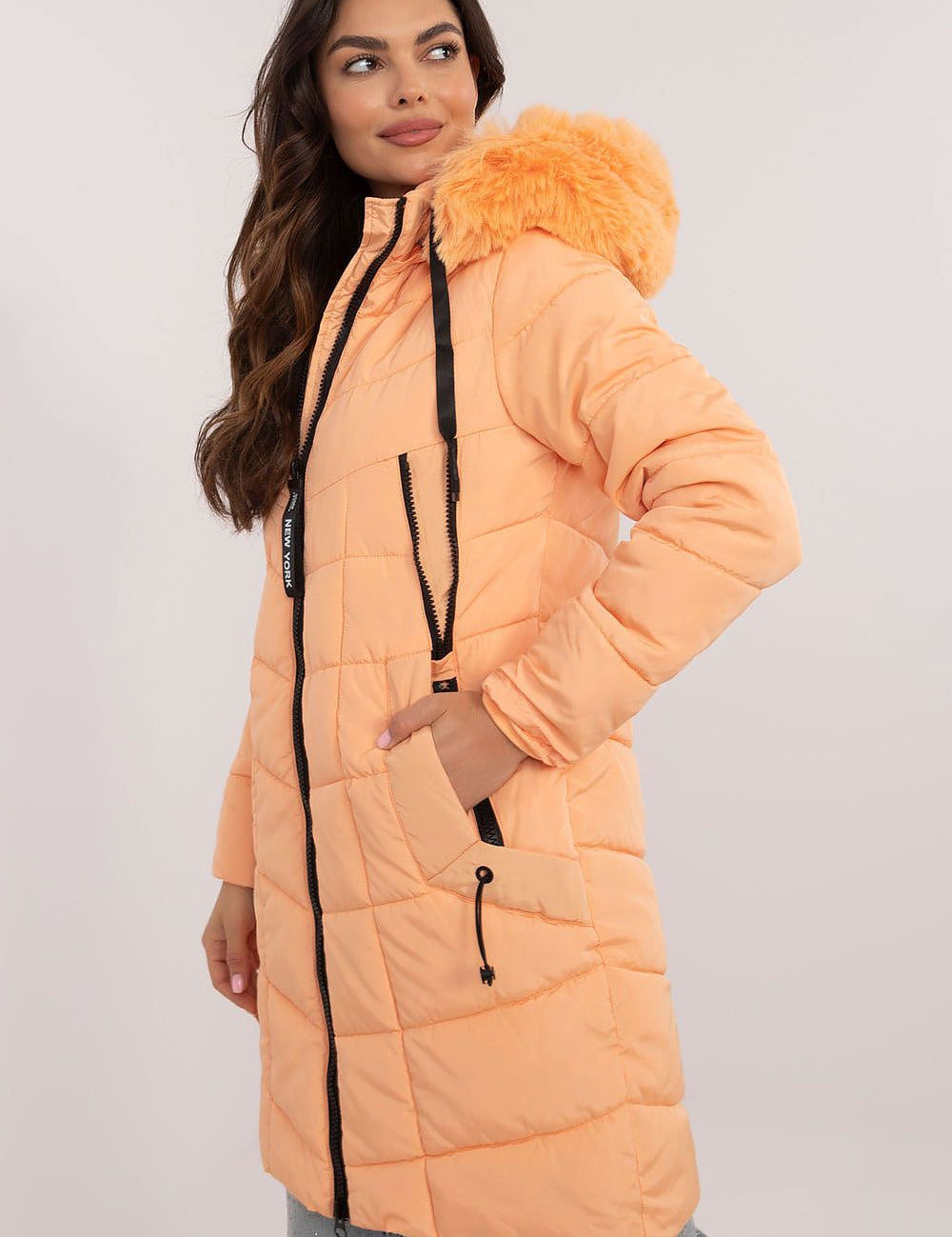Woman wearing Aurlis Quilted Winter Jacket with faux fur trim and quilted design for warmth and style.