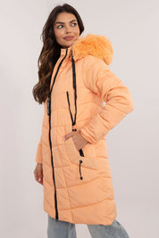 Woman wearing Aurlis Quilted Winter Jacket with faux fur trim and quilted design for warmth and style.