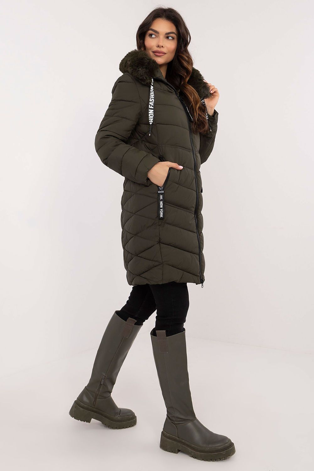 Woman wearing Frostveil Quilted Winter Jacket with detachable faux fur trim, showcasing warmth and style in knee-length design.