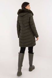 Rear view of woman wearing Frostveil Quilted Winter Jacket with detachable faux fur trim, showcasing knee-length quilted design.