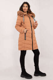Woman wearing Frostveil Quilted Winter Jacket with faux fur trim, showcasing warmth and style for cold weather.