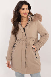 Woman wearing Frostveil Quilted Winter Jacket with detachable faux fur hood, showcasing its modern style and practical warmth.