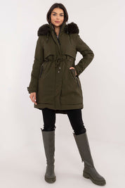 Woman wearing Frostveil Quilted Winter Jacket with faux fur trim and removable hood, styled for cold weather comfort and elegance.