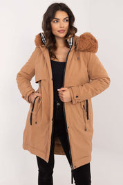 Woman wearing Frostveil Quilted Winter Jacket with faux fur trim and removable hood, showcasing modern style and warmth.
