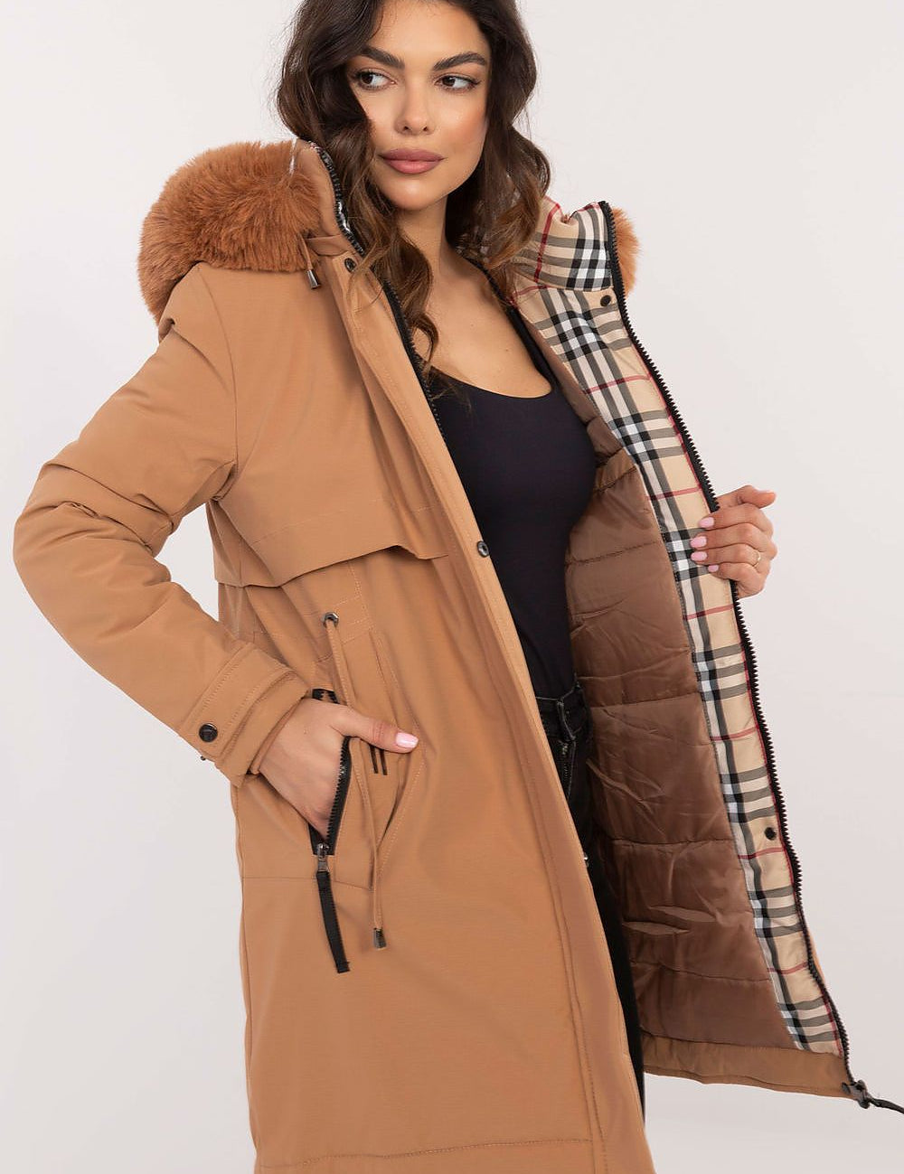 Woman wearing Frostveil Quilted Winter Jacket with removable hood and faux fur trim, showcasing modern style and warmth.