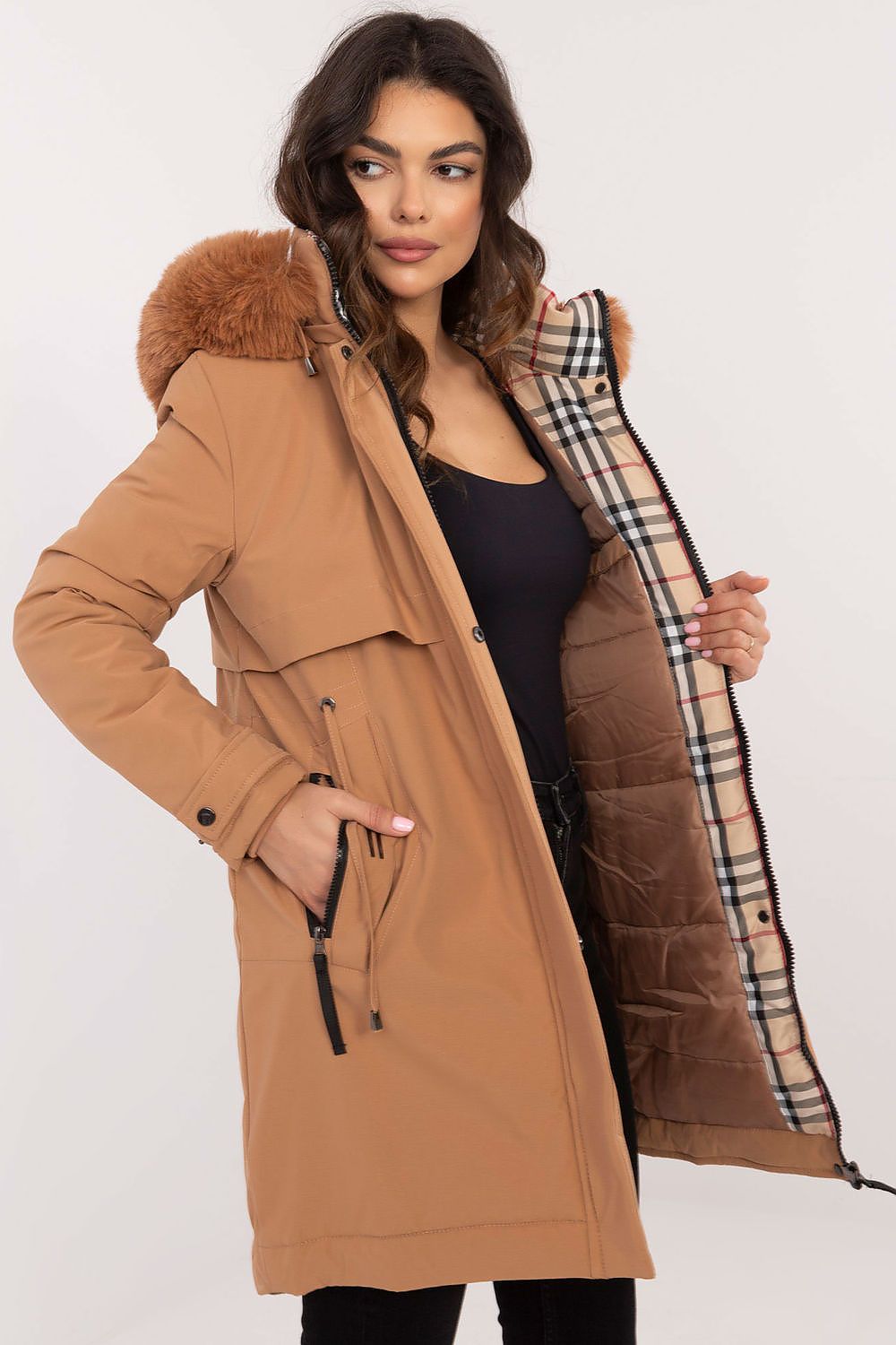 Woman wearing Frostveil Quilted Winter Jacket with removable hood and faux fur trim, showcasing modern style and warmth.