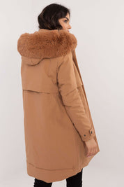 Woman wearing Frostveil Quilted Winter Jacket with faux fur trim and detachable hood, showcasing back design in camel color.