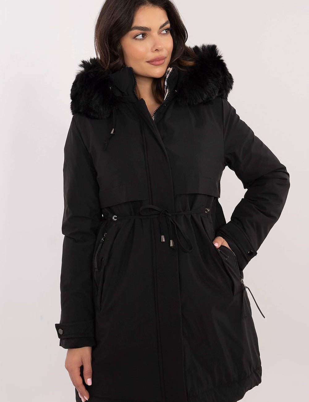 Woman modeling Frostveil Quilted Winter Jacket in black with faux fur trim and removable hood for warmth and modern style.