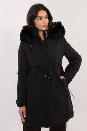 Woman modeling Frostveil Quilted Winter Jacket in black with faux fur trim and removable hood for warmth and modern style.