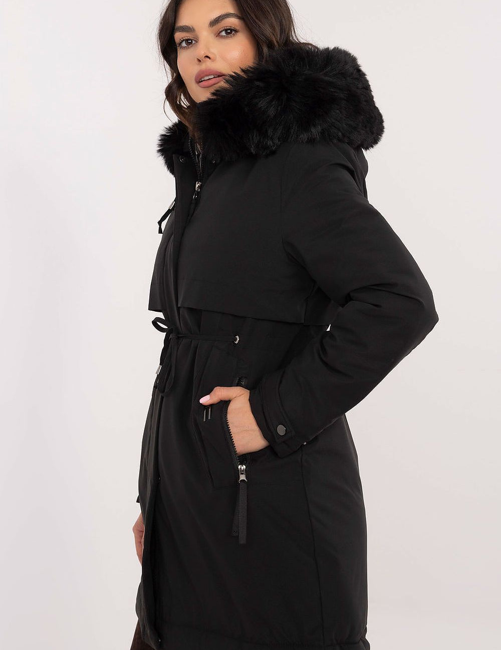 Woman wearing Frostveil Quilted Winter Jacket with detachable faux fur trim and removable hood, showcasing modern style and warmth.