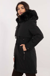 Woman wearing Frostveil Quilted Winter Jacket with detachable faux fur trim and removable hood, showcasing modern style and warmth.